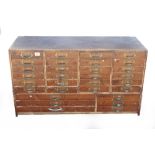 A 30 drawer chest of plywood construction with pine drawers and brass handles G+