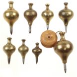 An accumulated set of 8 brass plumb bobs by PRESTON Nos 0,1,2,3,4,5,