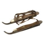 A pair of walnut ice skates with brass fittings by JOHN WILSON and stamped The Smart Skate with