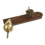 An A CLARKE'S Patent ratchet device for a 1 3/4 lbs brass plumb bob on mahogany board G