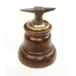 A clockmaker's anvil set in a mahogany base 8"h.
