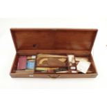 A draughtsman's mahogany box containing various French curves,rules,