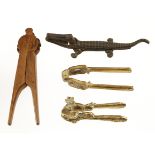 A very decorative chip carved wood nutcracker and 3 other in brass and iron G+