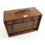 An engineers seven drawer oak chest with tools lacks front G