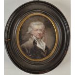A portrait miniature of a gentleman with powdered wig and spectacles,