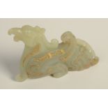 A Chinese gold inlaid apple green jade dragon in Chou style,