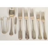 A crested finial silver spoon and matching fork and four various 19th century silver dessert forks,
