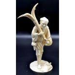 A Japanese ivory okimono, a fisherman standing holding a four bladed anchor,