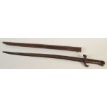 A Franco Prussian war bayonet, with a brass grip, length including scabbard 71cm.