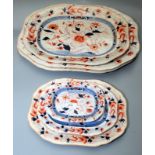 Six graduated Ironstone meat plates and stands decorated in red and blue with 'Indian' pattern.