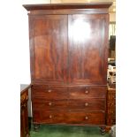 An early Victorian mahogany linen press with panel doors over two short and two long graduated