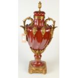 A pottery and gilt-brass urn imitating French ormolu and flambe glaze 65cm.