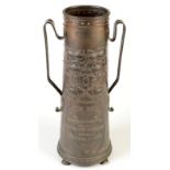 A fine Arts and Crafts copper vase of conical shape and with twin handles repousse decorated with