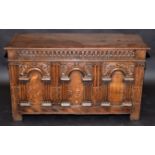 An oak joined chest in early 17th century style, the front with three arcaded panels, width 106cm.