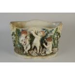 A large continental pottery jardiniere decorated with a cherub music ensemble, width 55cm,