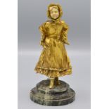 An Austrian gilt bronze and ivory figure of a girl in the manner of Kate Greenaway,