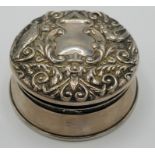 A small silver jewel box with embossed hinged lid.