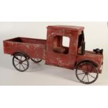 A child's red painted metal truck, length 72.5cm.