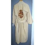 A Chinese cream linen dressing gown, the front embroidered with character marks,