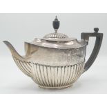 A late Victoria oval, half fluted silver teapot by William Hutton, London 1900, 22oz.