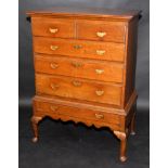 A George II oak chest, fitted two short and three long graduated drawers,