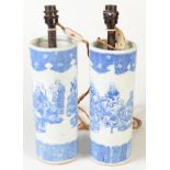 A pair of Chinese blue and white cylindrical vases decorated with a group of monks,