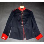 A Royal Engineers scarlet tunic, with blue velvet neck and cuffs and eleven original brass buttons,