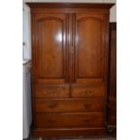 A late Victorian walnut linen press with panelled doors over two short and two long drawers.