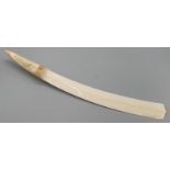 An Edwardian ivory paper knife, the handle carved with floral panels.