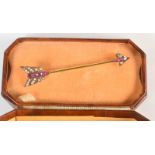 A 15ct. gold arrow brooch, set rubies and pearls.