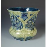 A William Moorcroft for Liberty green and blue floral jardiniere of bell form with shaped rim,