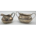 A half fluted silver sugar bowl and matching milk jug, Sheffield 1909, 15oz.