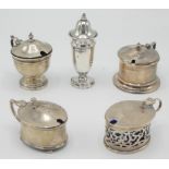 Four silver mustard pots and a silver salt.