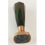 A gold mounted bloodstone desk seal with tapering faceted bloodstone handle and domed faceted top,