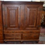 A Swedish oak armoire with panelled doors over drawers, width 162cm.