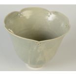 A studio porcelain celadon glazed, bowl the shaped rim with triple pierced motifs,