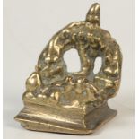 A miniature brass votive group with oil lamp and tree, width 3.25cm, height 4cm.