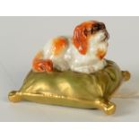 A Royal Worcester porcelain Pekinese on cushion, circa 1908, width 5cm.