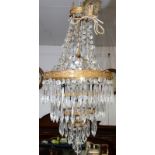 A brass, four tier lustre hung chandelier.