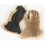 A pair of lady's fur and black leather gloves.