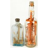 Two 'god in a bottle' folk art displays of carved wood Cornish miners tools, in glass bottles,