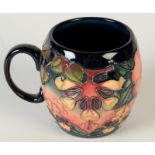 A Moorcroft Pottery mug, printed blue Moorcroft 'Made In England' mark to base and initialled MH,