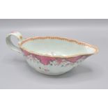 A Chinese export porcelain leaf shaped sauce boat with a wave rim, decorated in famille rose,