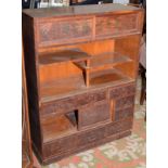 A Japanese wood tansu cabinet fitted drawers with shakudo mounts and three interspersed cupboards