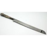 A bread knife with filled silver handle.