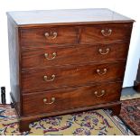 A George III mahogany chest of two short and three long graduated drawers with original brass