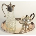 A claret jug, a teapot and an oval tray.