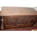 A George III oak mule chest, the front with three fielded panels over two drawers, width 138cm.