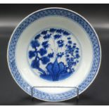 A Chinese blue and white plate decorated with rocks and three friends, pine tree,