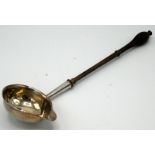 A silver George III punch ladle with turned wood handle.